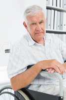 Portrait of a sad senior man sitting in wheelchair