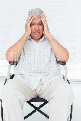 Sad senior man sitting in wheelchair