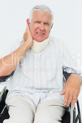 Senior man sitting in wheelchair with cervical collar