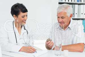 Doctor explaining reports to male patient