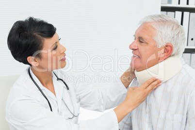 Female doctor examining a senior patients neck