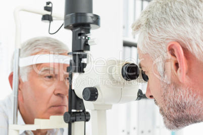 Optometrist doing sight testing for senior patient