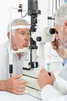 Optometrist doing sight testing for senior patient