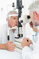 Optometrist doing sight testing for senior patient