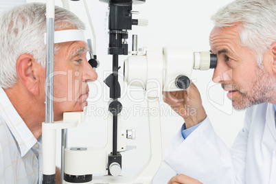 Optometrist doing sight testing for senior patient