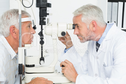 Optometrist doing sight testing for senior patient