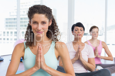 Women with joined hands at fitness studio