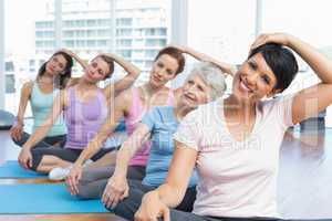 Class stretching neck in row at yoga class