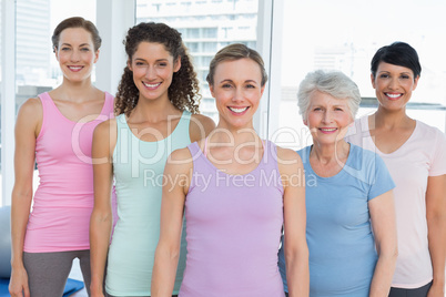 Smiling women standing in yoga class