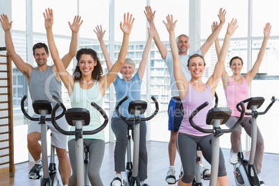 Happy people working out at spinning class