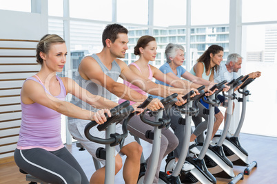 Determined people working out at spinning class