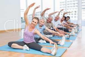 Class stretching hands at yoga class