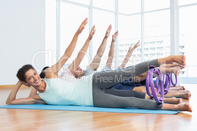 Class stretching legs and hands in row at yoga class