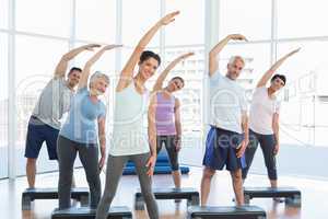 Class stretching hands in yoga class