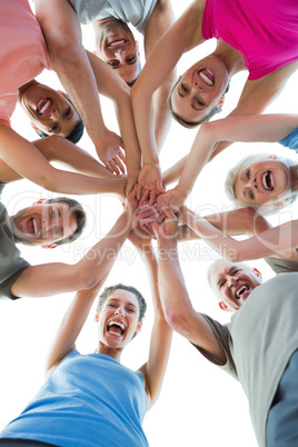Happy sporty people holding hands together Happy sporty people holding hands together