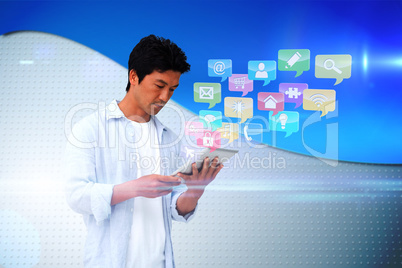 Casual man using tablet with app icons