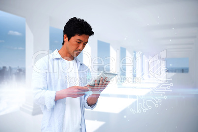 Casual man using tablet with circuit board