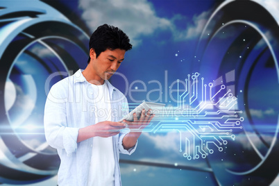 Casual man using tablet with circuit board