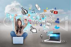Cheering girl using laptop with app icons