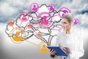 Blonde businesswoman using tablet pc with cloud computing graphi