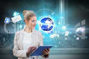 Blonde businesswoman using tablet pc with earth and emails