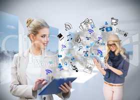 Blonde businesswoman using tablet pc with app icons