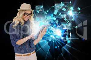 Stylish blonde using tablet pc email and interfaces