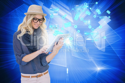 Stylish blonde using tablet pc email and interfaces