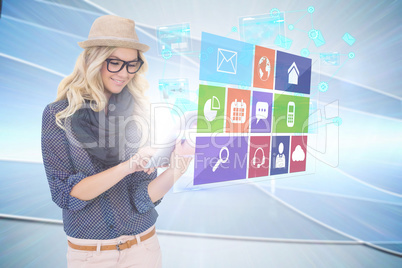 Stylish blonde using tablet pc with app icon menu