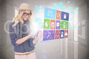 Stylish blonde using tablet pc with app icon menu