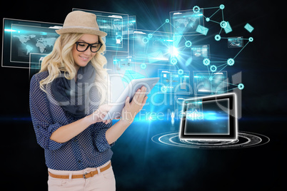 Stylish blonde using tablet pc with interfaces and email icons