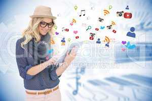Stylish blonde using tablet pc with app icons