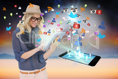 Stylish blonde using tablet pc with app icons and smartphone