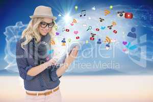 Stylish blonde using tablet pc with app icons