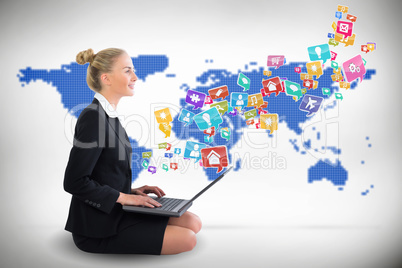 Blonde businesswoman sitting using laptop with app icons