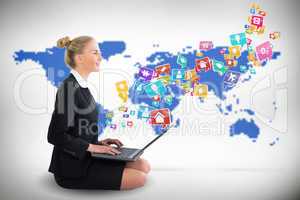 Blonde businesswoman sitting using laptop with app icons
