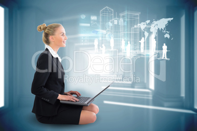 Blonde businesswoman sitting using laptop with interface