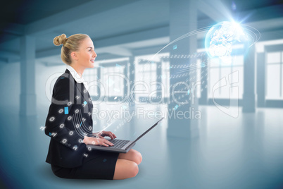 Blonde businesswoman sitting using laptop with interface