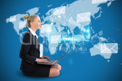Blonde businesswoman sitting using laptop with earth interface
