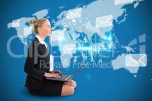 Blonde businesswoman sitting using laptop with earth interface