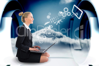 Blonde businesswoman sitting using laptop with cogs and wheels