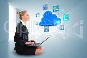 Blonde businesswoman sitting using laptop with cloud and app ico