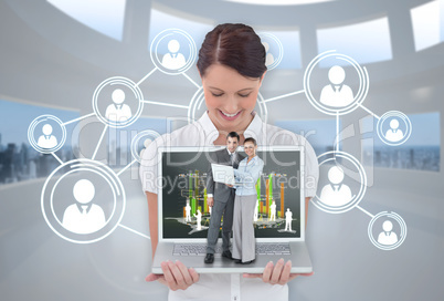 Happy businesswoman showing laptop with business people on it Happy businesswoman showing laptop with business people on it