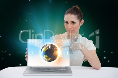 Businesswoman pointing to her laptop showing earth graphic