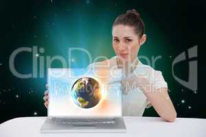 Businesswoman pointing to her laptop showing earth graphic