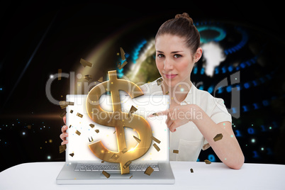 Businesswoman pointing to her laptop showing dollar sign