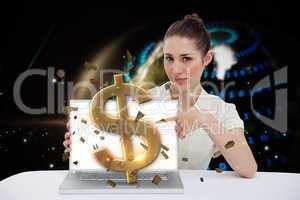 Businesswoman pointing to her laptop showing dollar sign