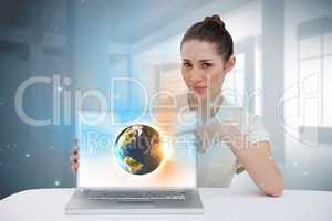 Businesswoman pointing to her laptop showing earth graphic