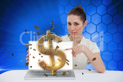Businesswoman pointing to her laptop showing dollar sign