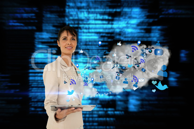 Businesswoman holding tablet with cloud and app icons